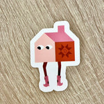 Sticker of a pink house character wearing cowboy boots on a wooden surface.